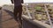 Rear view of fit african american man exercising outdoors in city, running on footbridge