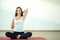 Rear view of fit woman doing gomukhasana in yoga class