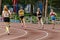 rear view four women athletes runners running sprint race