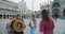 Rear view four young happy beautiful diverse women walking along amazing summer San Marco square on Venice vacation.