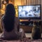 Rear view of girl and a cat watching TV together Generative AI