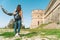 Rear view of a girl discovering medieval castle in Italy