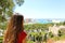 Rear view of girl looking at Malaga sight with the city hall on the right, Gibralfaro viewpoint, Malaga, Spain