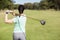 Rear view of golfer woman taking shot