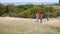 Rear View Of Group Of Children On Outdoor Activity Camping Trip Running Down Hill