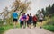 Rear view of group of multi generation people running a race competition in nature.