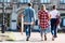 rear view of group of teen students walking in front of old