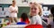 Rear view of happy Caucasian schoolgirl looking at camera in the classroom 4k