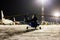 Rear view of the helicopter and passenger airplanes on the airport apron at winter night
