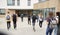 Rear View Of High School Students Walking Into College Building Together