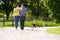 Rear View Of Hispanic Couple Walking Dog