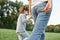 Rear view image of cute little girl playing with her mother. Loving beautiful woman and her daughter spending time together and