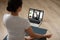 Rear view Indian woman practicing yoga, watching webinar, using laptop