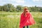 rear view of kid in red superhero cape and mask standing