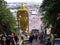 Rear view of the large golden statue of Murugan and people on the stairs going up to the Batu Caves. Malaysia