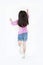 Rear view little kid girl jumping over white background. Freedom kid movement concept