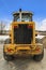 Rear view of a loader against snow covered ground and cloudy blue sky in winter