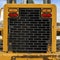 Rear view of a loader against snow covered ground and cloudy blue sky in winter