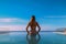 Rear view of a long hair woman in bikini in infinity pool, Generative Ai