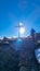 Rear view of man with hiking backpack reaching summit cross of mountain peak Gertrusk, Saualpe, Lavanttal Alps, Carinthia