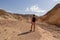 Rear view of man hiking in golden Canyon with scenic view of colorful geology of multi hued Amargosa Chaos rock formations