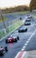 Rear view of many racing single seater formula cars exit from motorsport