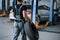 Rear view. Mechanic holds a tire at the repair garage. Replacement of winter and summer tires