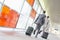 Rear view of middle aged businessmen with luggage rushing on railroad platform