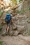 Rear view of middle aged caucasian man climbing rocks