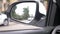 Rear view mirror of the car with traces of rain. a blurry reflection in the rear-view mirror of a car standing on the