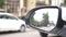 Rear view mirror of the car with traces of rain. a blurry reflection in the rear-view mirror of a car standing on the