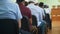 Rear view of muslim men in skullcaps sitting at the mass rally