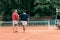 rear view of old-fashioned friends with wooden rackets walking