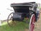 Rear view of old-fashioned horse carriage on green grass