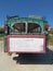 Rear view of an old rusting green painted bus with roof rack parked in a rustic location in cyprus