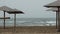 Rear view of one empty sun lounger stands across from the Sea on beach.