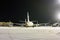 Rear view of the passenger aircrafts on the airport apron at winter night