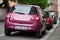 Rear view of pink Renault Twingo parked in the street