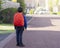 Rear view portrait of Cheerful Child carrying school backpack walking for bus, School kid wearing uniform, Pupil of primary going