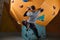 Rear view of powerful physically challenged boulderer climbing at rock wall