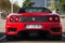 Rear view of red Ferrari 360 Modena parked in the street