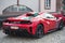 Rear view of red Ferrari 488 pista parked in the street