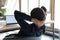 Rear view relaxed Indian businesswoman leaning back in office chair