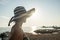 Rear view of a relaxed woman wearing a striped straw hat at the