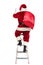 Rear view of santa claus with sack on shoulder climbing