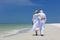 Rear View Senior Couple Walking on Tropical Beach