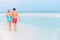 Rear View Of Senior Romantic Couple Walking In Tropical Sea