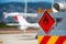 Rear view of service and refuelling truck on an airport with an aircraft in the blurry background.