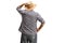 Rear view shot of a farmer looking at the distance and holding his straw hat