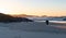 Rear View of Silhouette of a Person Practicing Yoga on the Beach at Sunrise Time